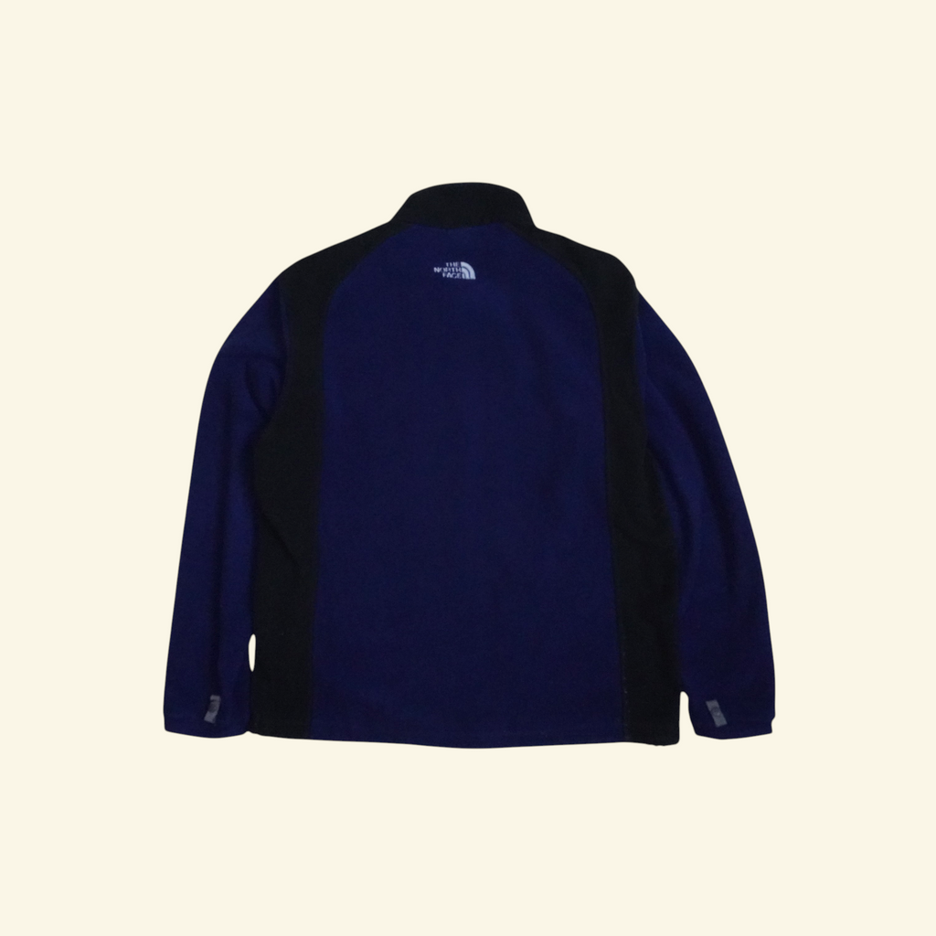 Chamarra de forro polar Mi tienda The North Face en colorblock azul marino y negro, vista trasera.